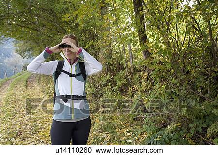 Woman looking through binoculars View Large Photo Image Stock Image - Woman looking through binoculars. Fotosearch