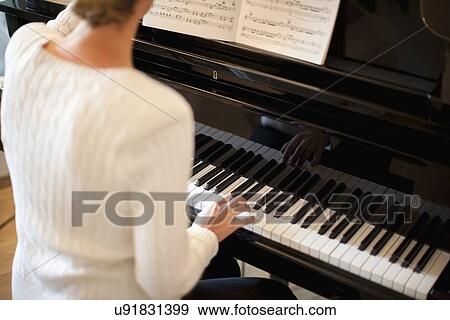 Woman playing piano View Large Photo Image Stock Photo - Woman playing piano. Fotosearch
