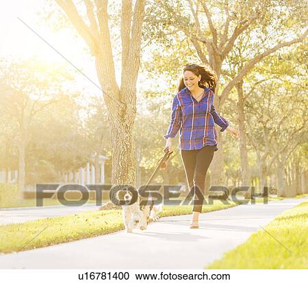 Woman running with her dog View Large Photo Image Stock Image - Woman running with her dog. Fotosearch