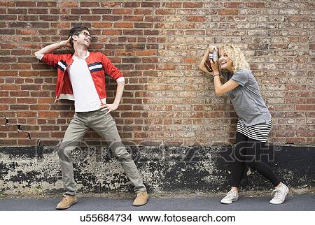 Woman taking pictures of man View Large Photo Image Picture - Woman taking pictures of man. Fotosearch