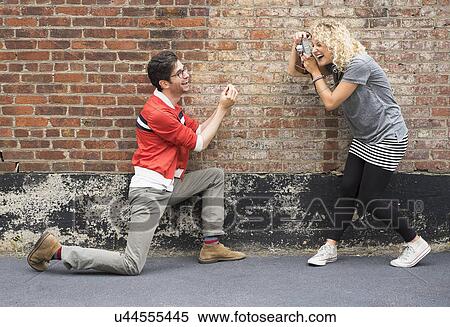 Woman taking pictures of man View Large Photo Image Stock Photography - Woman taking pictures of man. Fotosearch