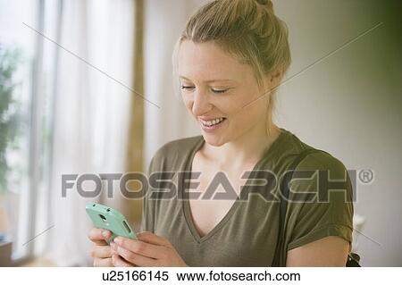Stock Photography - Woman texting on mobile phone. Fotosearch