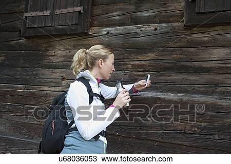 Woman using cell phone and drinking from bottle View Large Photo Image Stock Image - Woman using cell phone and drinking from bottle. Fotosearch