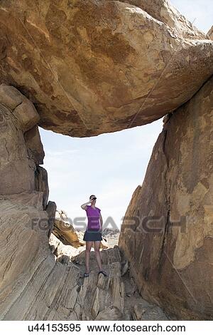 Stock Photography - "Woman visiting Balanced Rock, looking through binoculars". Fotosearch