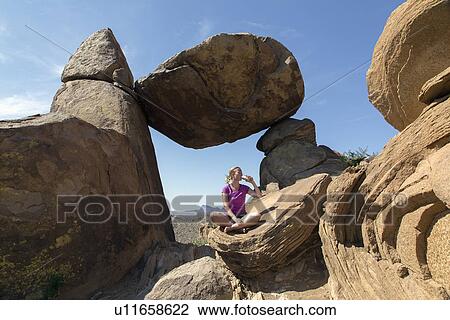 Stock Image - Woman visiting Balanced Rock . Fotosearch