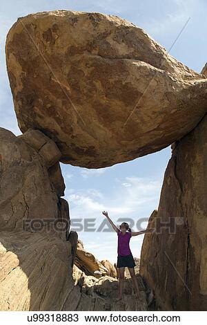 Stock Image - Woman visiting Balanced Rock . Fotosearch
