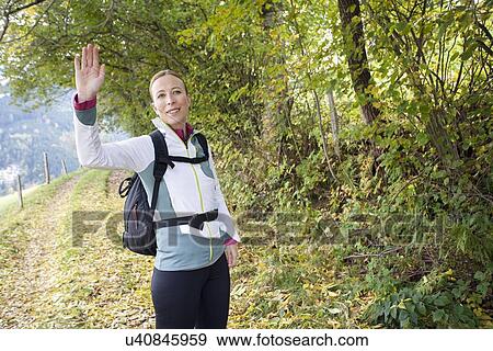 Woman waving at camera View Large Photo Image Stock Photo - Woman waving at camera. Fotosearch