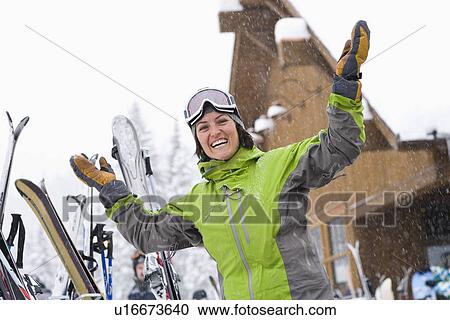 Woman wearing ski googles with hands raised View Large Photo Image Stock Image - Woman wearing ski googles with hands raised. Fotosearch