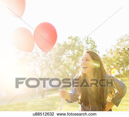 Woman with balloons outdoors View Large Photo Image Stock Image - Woman with balloons outdoors. Fotosearch