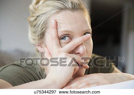 Woman with hand on her face View Large Photo Image Stock Photo - Woman with hand on her face. Fotosearch