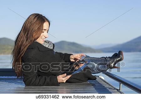 Woman with tablet by lake View Large Photo Image Stock Image - Woman with tablet by lake. Fotosearch