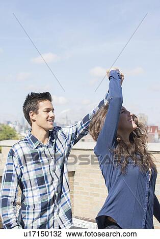 Young couple dancing on roof View Large Photo Image Stock Image - Young couple dancing on roof. Fotosearch