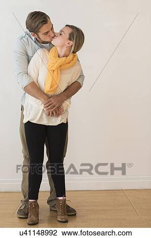 Young couple embracing and kissing View Large Photo Image Stock Image - Young couple embracing and kissing. Fotosearch