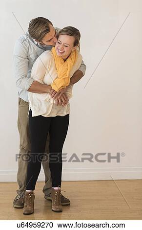 Young couple embracing and kissing View Large Photo Image Stock Image - Young couple embracing and kissing. Fotosearch