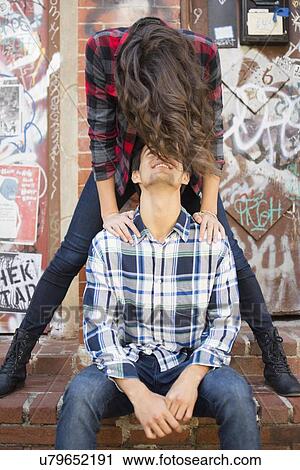 Young couple face to face on sidewalk View Large Photo Image Stock Image - Young couple face to face on sidewalk. Fotosearch