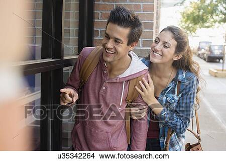 Picture - Young couple walking on street. Fotosearch