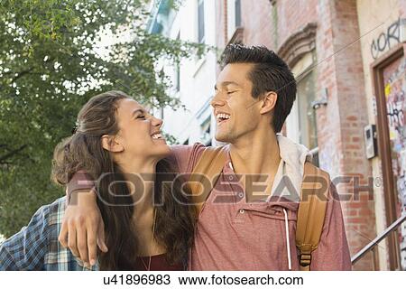 Young couple walking on street View Large Photo Image Stock Image - Young couple walking on street. Fotosearch