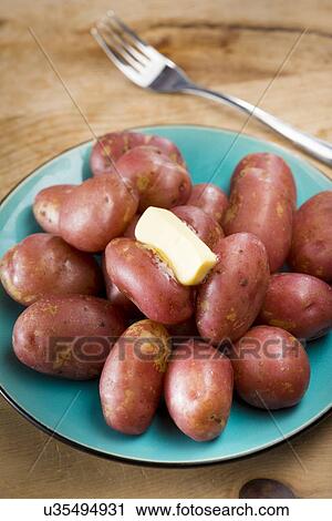 Stock Image - King Edward potatoes on a plate. Fotosearch