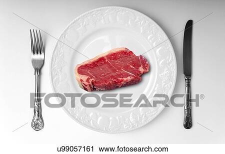 Raw meat on white plate View Large Photo Image Stock Image - Raw meat on white plate. Fotosearch
