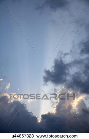 Suns rays through clouds View Large Photo Image Stock Image - Suns rays through clouds. Fotosearch