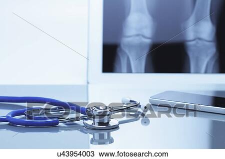 Acoustic stethoscope and smartphone on office desk with digital tablet displaying knee xray View Large Photo Image Stock Image - Acoustic stethoscope and smartphone on office desk with digital tablet displaying knee xray. Fotosearch