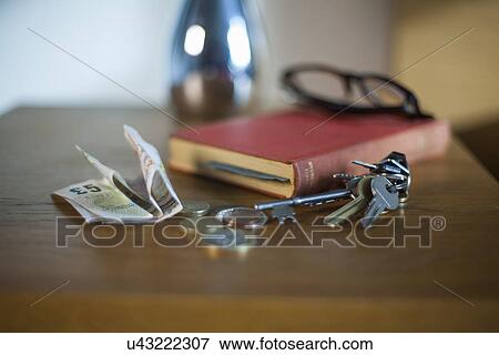 "Bank notes, coins, book, keys and reading glasses" View Large Photo Image Stock Photo - "Bank notes, coins, book, keys and reading glasses". Fotosearch