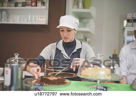 Barista serving chocolate cake at cafe View Large Photo Image Stock Photo - Barista serving chocolate cake at cafe. Fotosearch