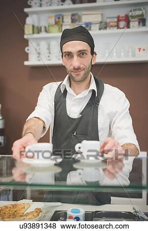 Barista serving coffee over the counter View Large Photo Image Stock Photo - Barista serving coffee over the counter. Fotosearch