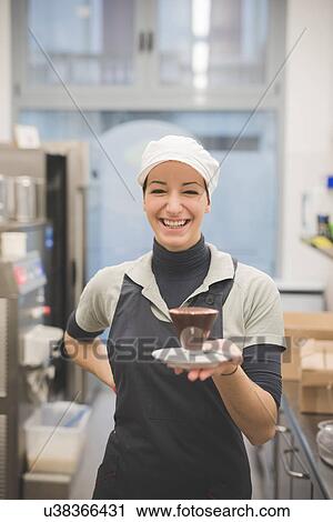 Stock Image - Barista serving hot chocolate at cafe. Fotosearch