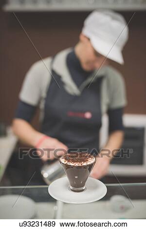 Barista serving hot chocolate at cafe View Large Photo Image Stock Photo - Barista serving hot chocolate at cafe. Fotosearch