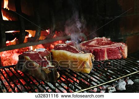 Bistecca fiorentina (T bone steaks) grilling in front of open fire View Large Photo Image Stock Photograph - Bistecca fiorentina (T bone steaks) grilling in front of open fire. Fotosearch