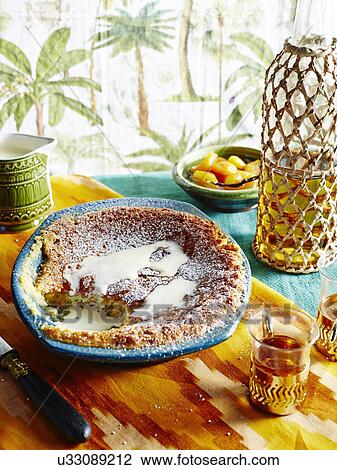 Stock Image - Bowl of cake and dairy cream with glass of white vinegar. Fotosearch