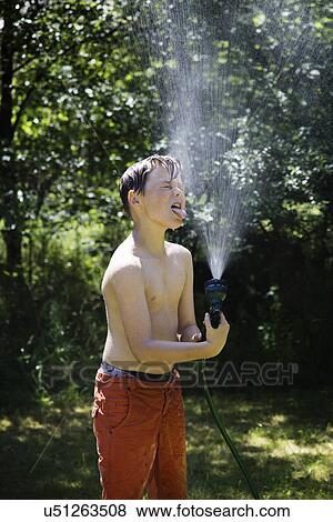 Boy playing with garden hose View Large Photo Image Stock Photo - Boy playing with garden hose. Fotosearch