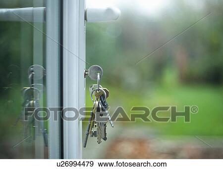 Bunch of keys left hanging in door View Large Photo Image Stock Photo - Bunch of keys left hanging in door. Fotosearch
