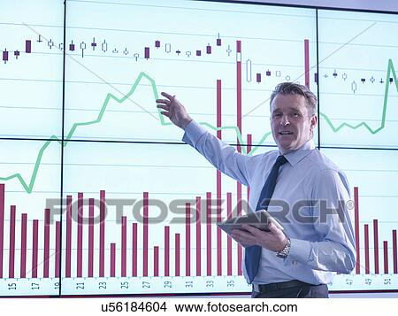 "Businessman making presentation in front of graphs on screen, portrait" View Large Photo Image Picture - "Businessman making presentation in front of graphs on screen, portrait". Fotosearch
