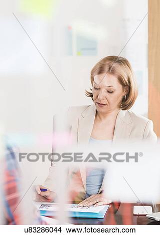 Businesswoman interviewing candidate at office desk View Large Photo Image Picture - Businesswoman interviewing candidate at office desk. Fotosearch