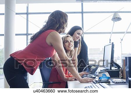 Businesswoman presenting ideas to team at office desk meeting View Large Photo Image Stock Image - Businesswoman presenting ideas to team at office desk meeting. Fotosearch