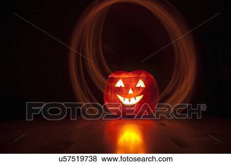 Stock Photo - "Carved pumpkin, long exposure". Fotosearch