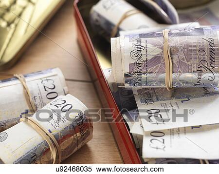 Cash savings in biscuit tin View Large Photo Image Stock Photography - Cash savings in biscuit tin. Fotosearch