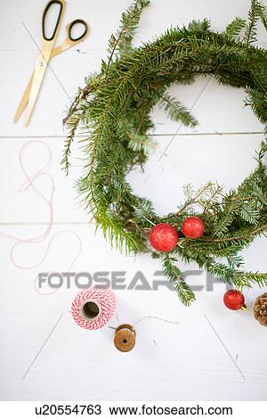 Stock Image - "Christmas wreath, scissors, thread, baubles". Fotosearch