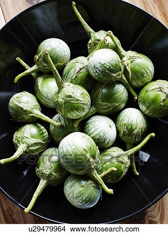 Picture - Close up of apple eggplants in bowl. Fotosearch