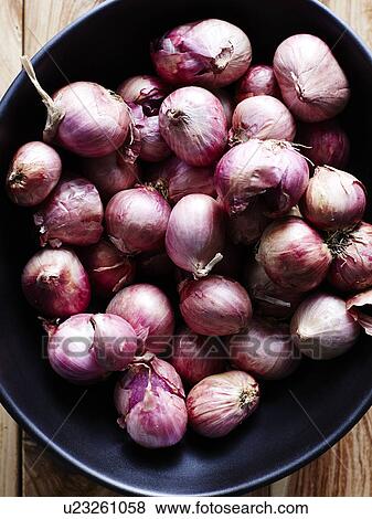 Stock Photo - Close up of Asian shallots in bowl. Fotosearch