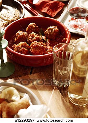 Stock Photo - Close up of bowl of meatballs in spicy sauce. Fotosearch