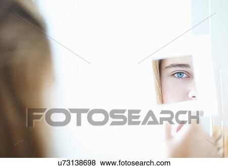 Close up over the shoulder view of teenage girl in hand mirror View Large Photo Image Stock Photo - Close up over the shoulder view of teenage girl in hand mirror. Fotosearch