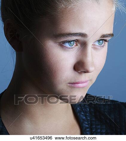 Stock Photograph - Close up portrait of pretty teenage girl with blue eyes. Fotosearch