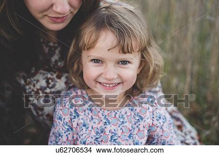 Picture - Close up portrait of young girl and mother. Fotosearch