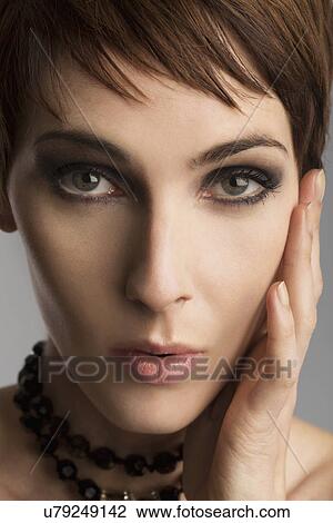 Close up studio portrait of beautiful woman with hand on cheek View Large Photo Image Stock Image - Close up studio portrait of beautiful woman with hand on cheek. Fotosearch