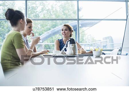 Colleagues having breakfast meeting View Large Photo Image Stock Image - Colleagues having breakfast meeting. Fotosearch