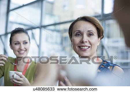 Stock Image - Colleagues having coffee break. Fotosearch