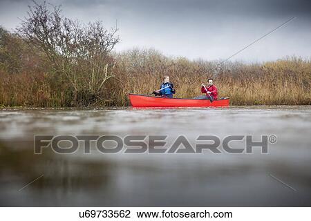 Stock Image - Couple canoeing. Fotosearch